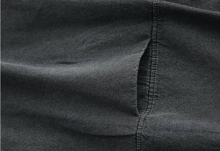 dark gray denim fabric with a visible seam and pocket detail on the retro artistic plus size dark gray denim tunic dress.