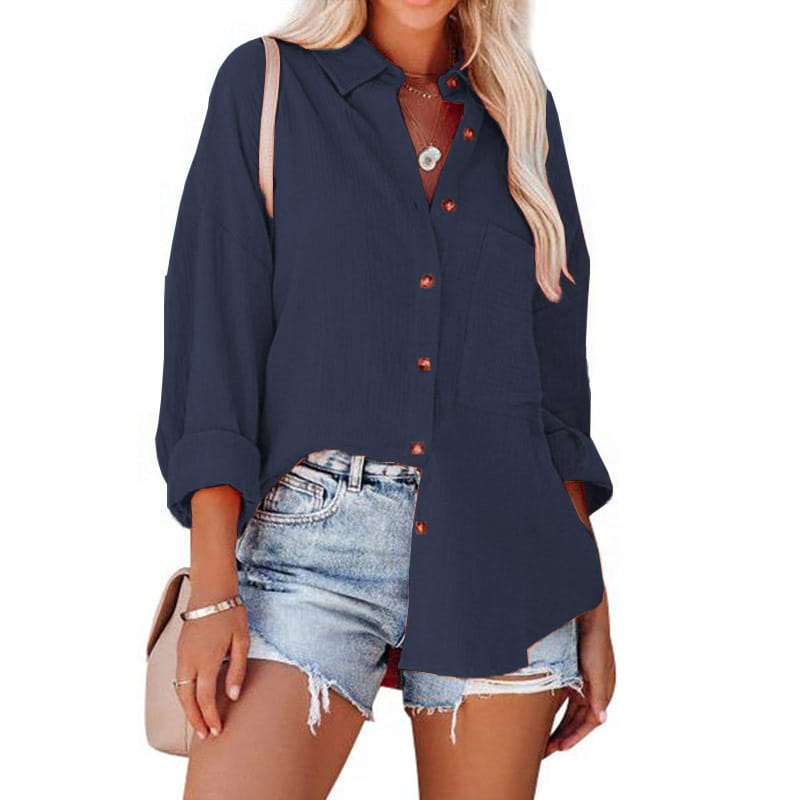 Navy blue women’s relaxed fit dropped shoulder button up shirt with rust-colored buttons and rolled cuffs made from soft breathable fabric.