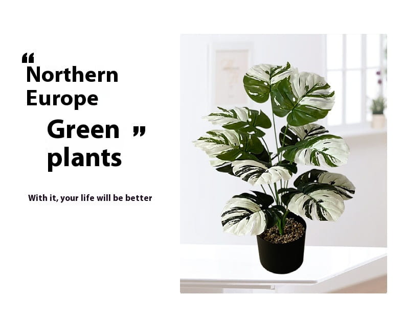 Artificial monstera turtle leaf potted plant with variegated green and white leaves in a black pot for garden decor.