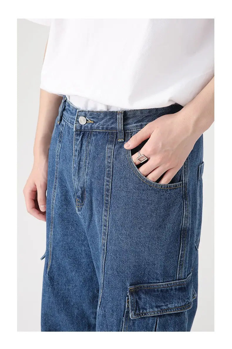 Blue denim cargo pants with a relaxed fit, wide leg, and multiple pockets in a retro style.