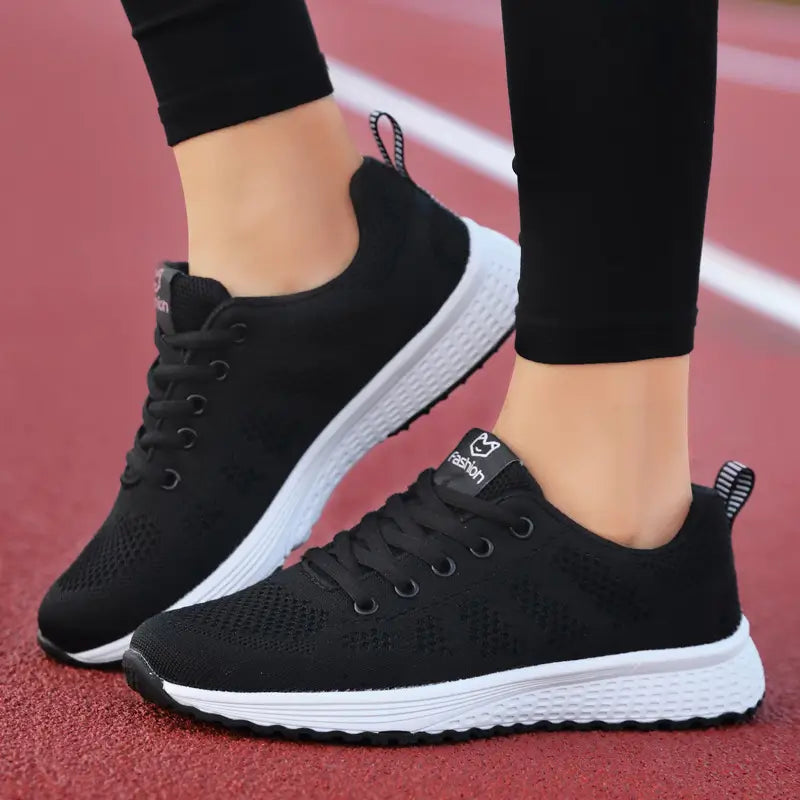 Black mesh fly woven sneakers with white soles and laces featuring a small fashion logo on the tongue, breathable athletic shoes.