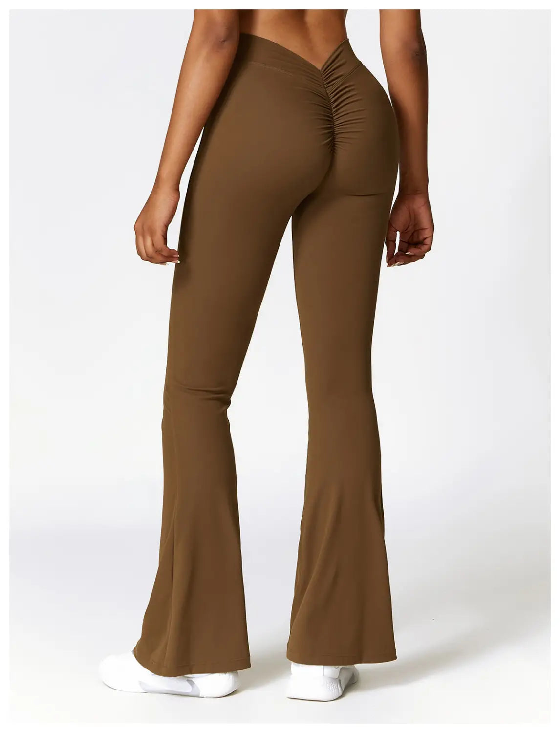 brown high-waisted flared yoga pants with a ruched back design for activewear use shown from the back side.