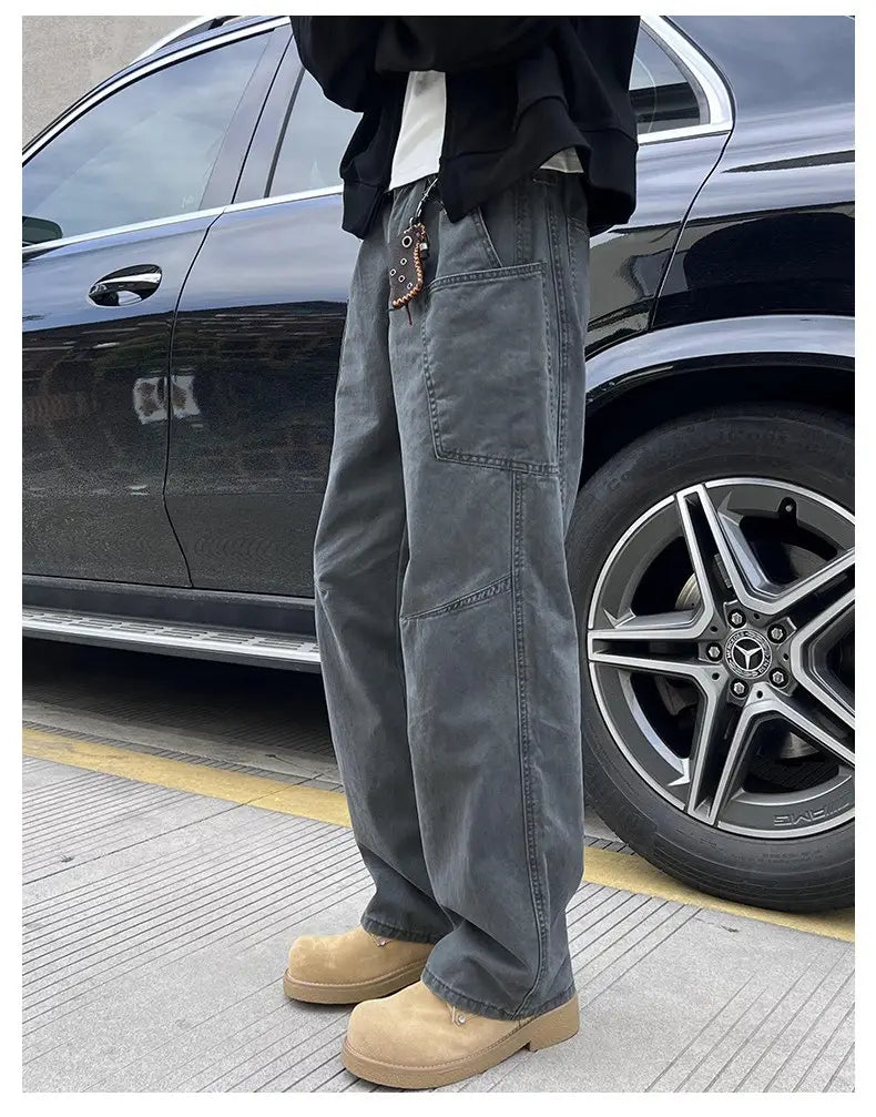 Dark gray wide-leg cotton cargo pants for men featuring multiple pockets and a relaxed fit suitable for workwear.