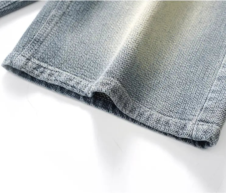 Men’s elastic waist light wash denim shorts with a subtle gradient fade from dark to light gray featuring a classic woven texture and neatly stitched hem.