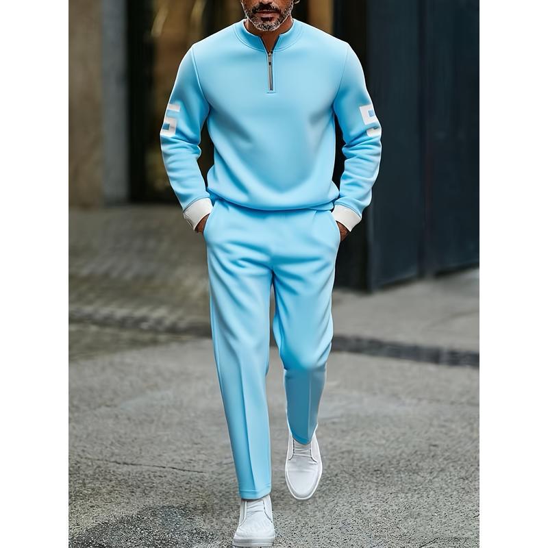 Light blue half zip athletic sweatsuit printed set with white trim on cuffs and a quarter-zip neckline designed for activewear.
