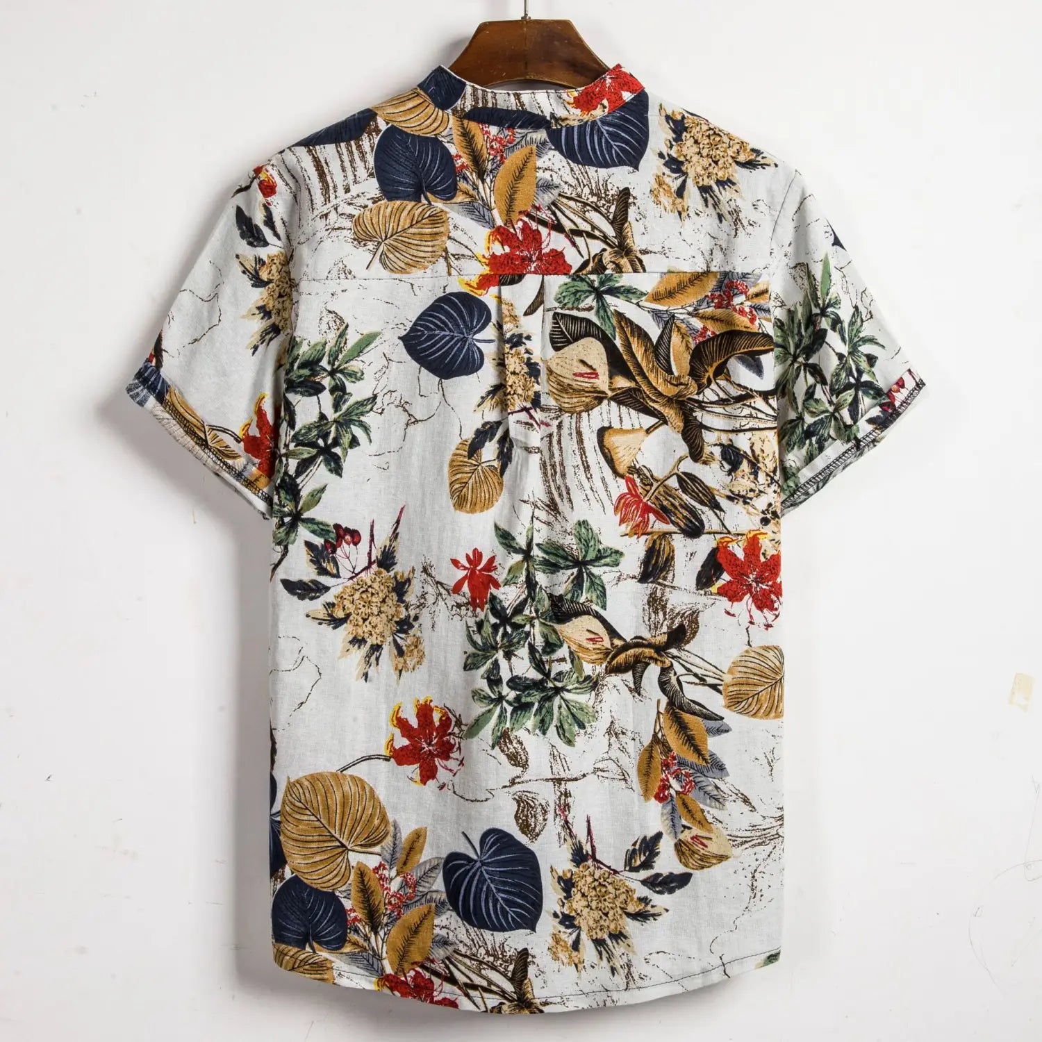 Men slim fit tropical floral short sleeve button shirt in white featuring a vibrant red green and gold leaf and flower print.