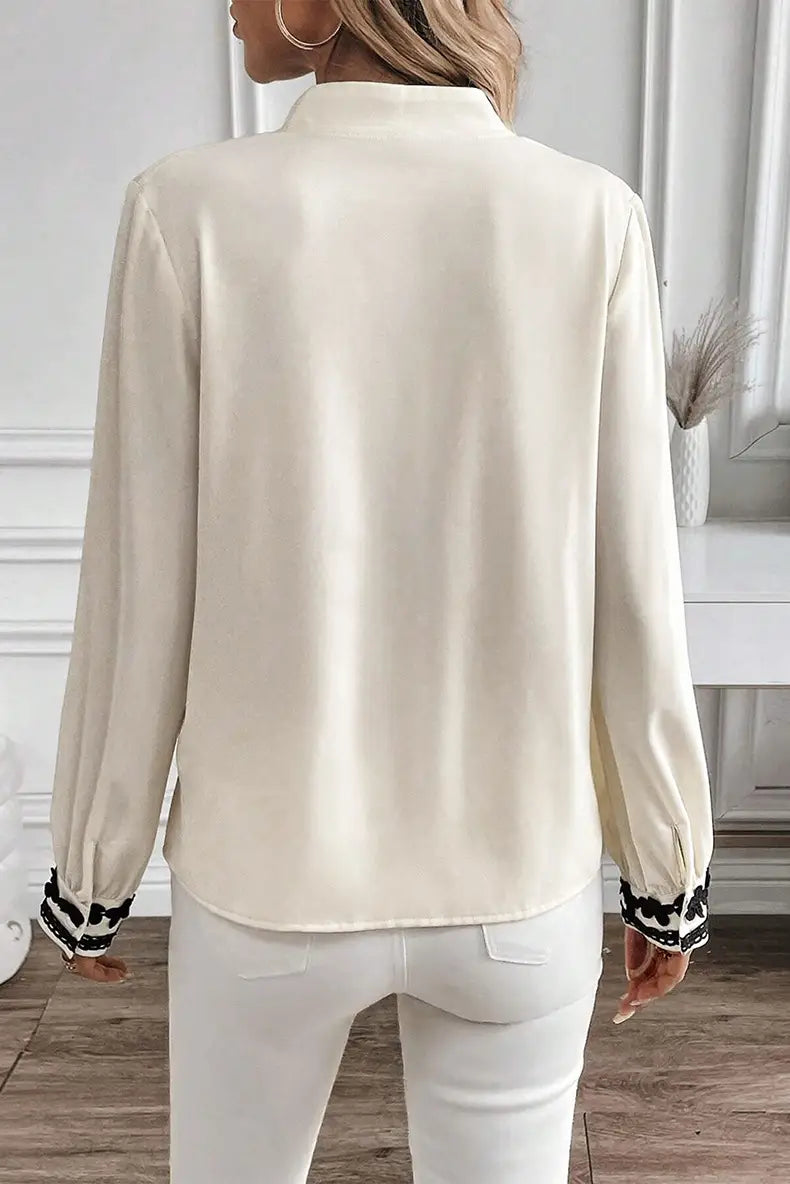 floral embroidered long sleeve cream satin blouse with lace trim and black and white polka dot cuffs