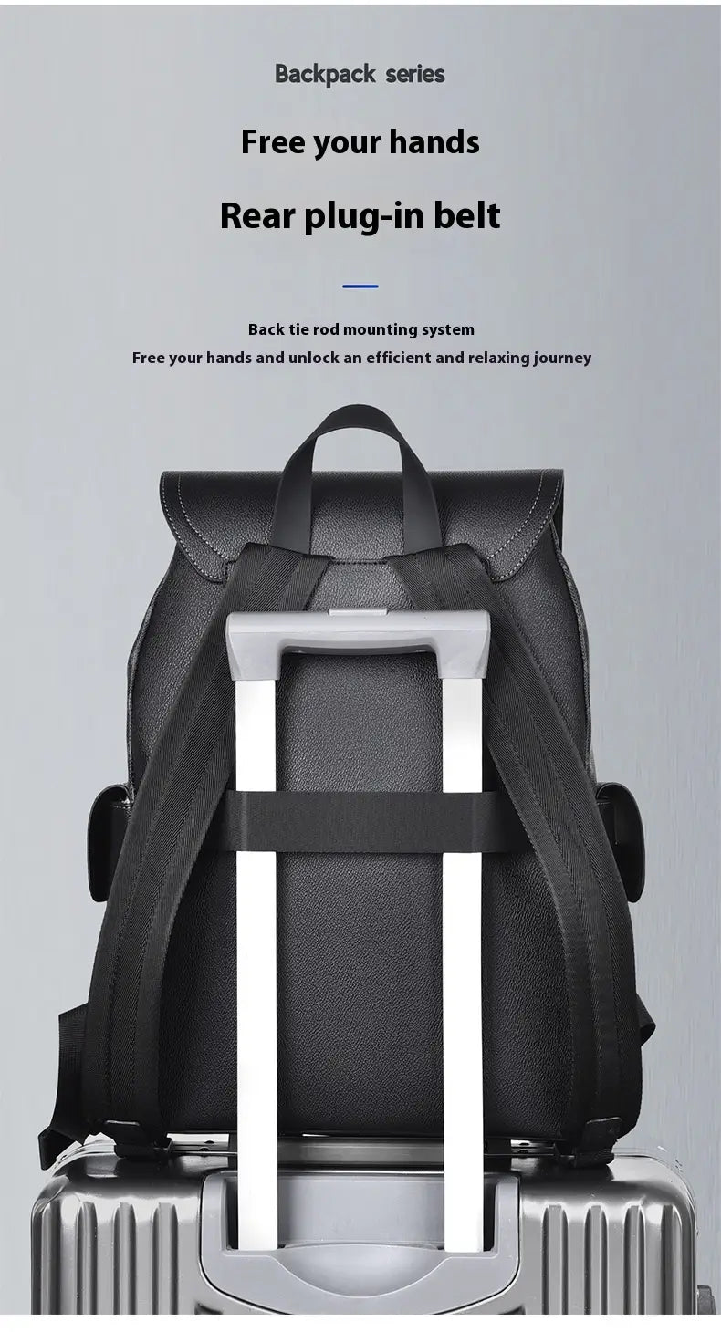 Black leather men’s business travel backpack with laptop sleeve shown from the back with rear plug-in belt and silver handle.