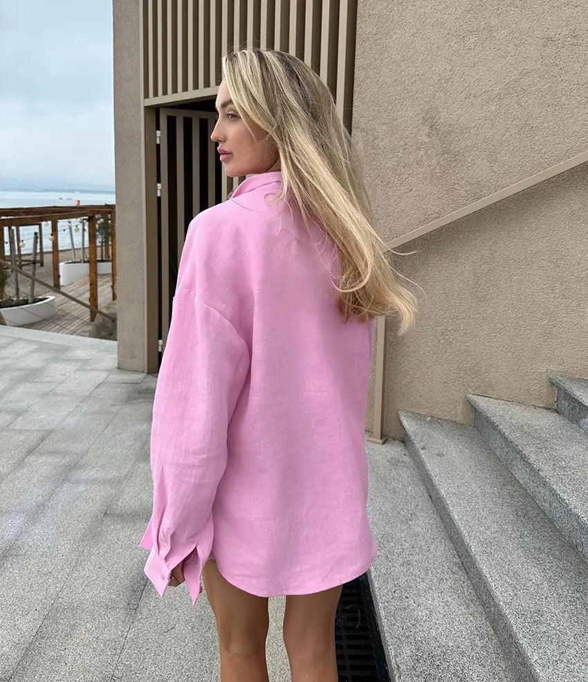 A soft pink oversized textured button up cardigan blouse with long sleeves and a relaxed fit for women.