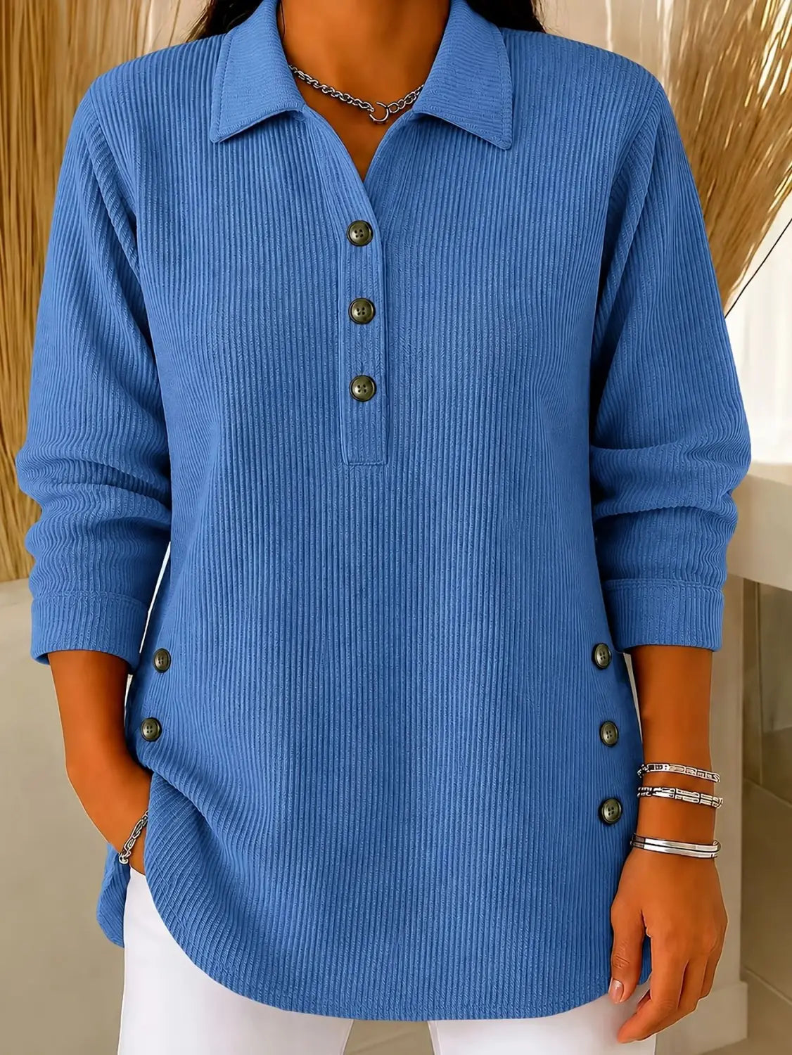 Blue ribbed knit polo shirt with three-quarter sleeves and dark green buttons is a casual long sleeve top ideal for everyday wear.