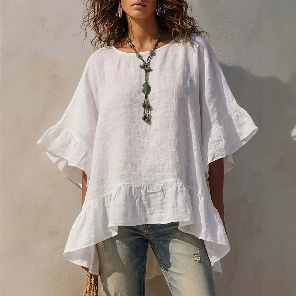 White linen cotton linen ruffle hem shirt with flared sleeves and a ruffled hem for a stylish casual look