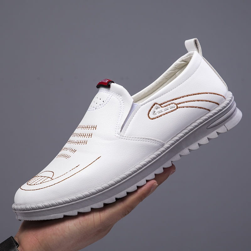 Men’s lightweight breathable white faux leather slip on shoe with brown embroidered detailing and textured rubber sole