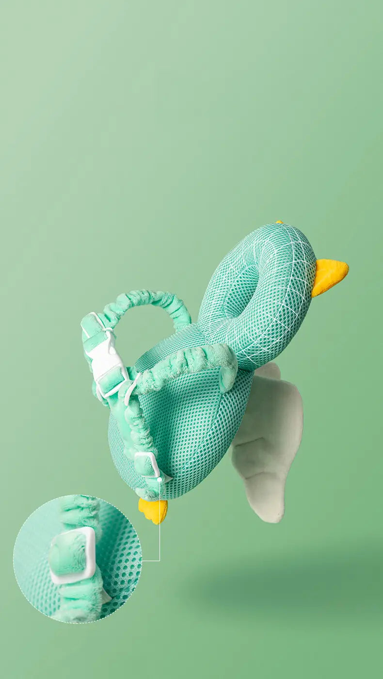 A mint green mesh duck-shaped baby head protector anti fall plush backpack cushion with yellow beak and feet featuring adjustable straps and a white buckle.