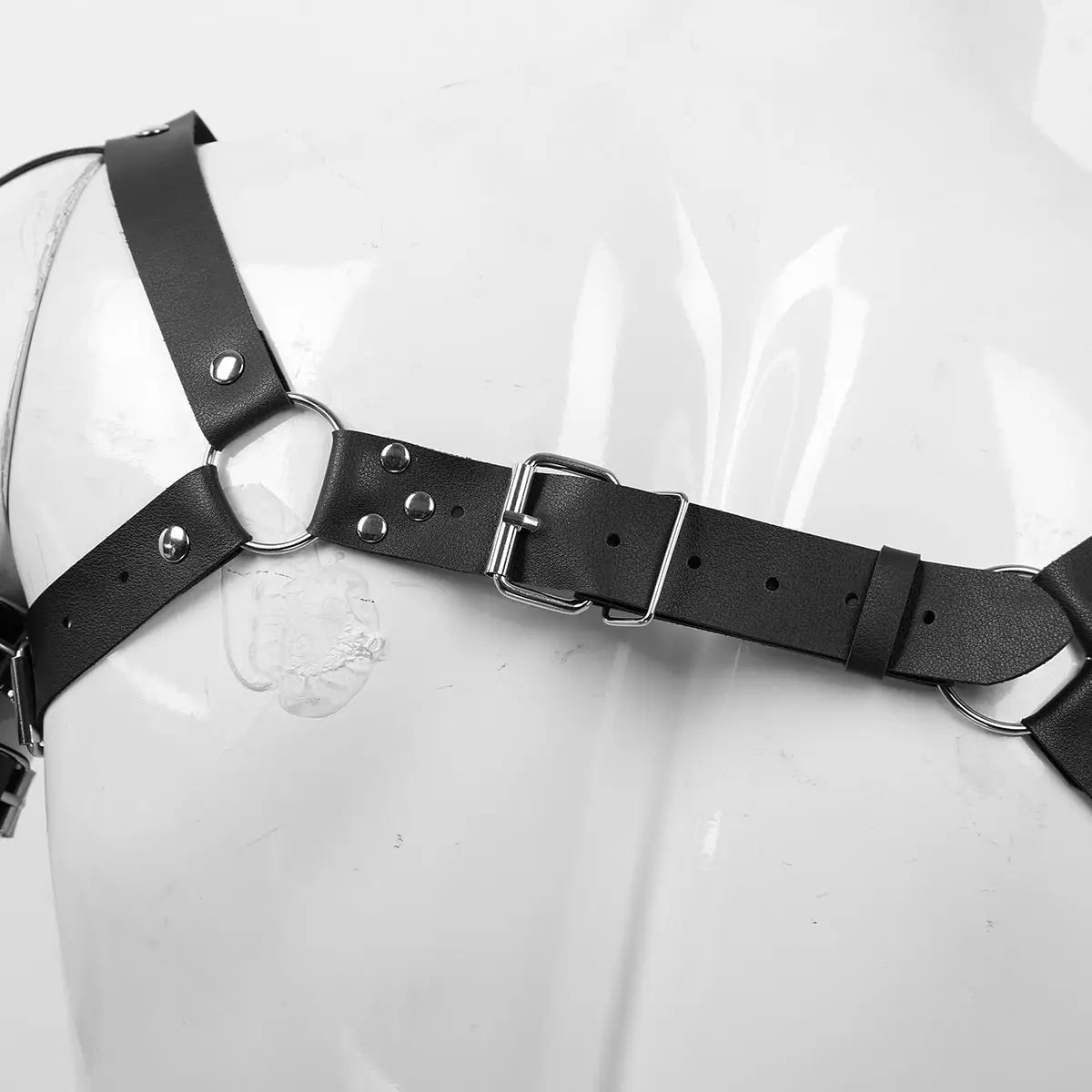 Men’s leather chest harness in black featuring silver-toned metal rings and an adjustable buckle made from leather.