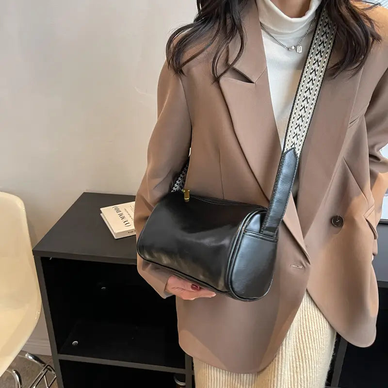 Black leather retro crossbody bag with a patterned strap for stylish everyday use