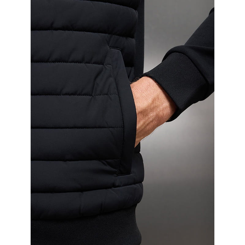 Black quilted puffer vest with ribbed cuff and front pocket featured in a men’s quilted lightweight bomber jacket with stand collar.