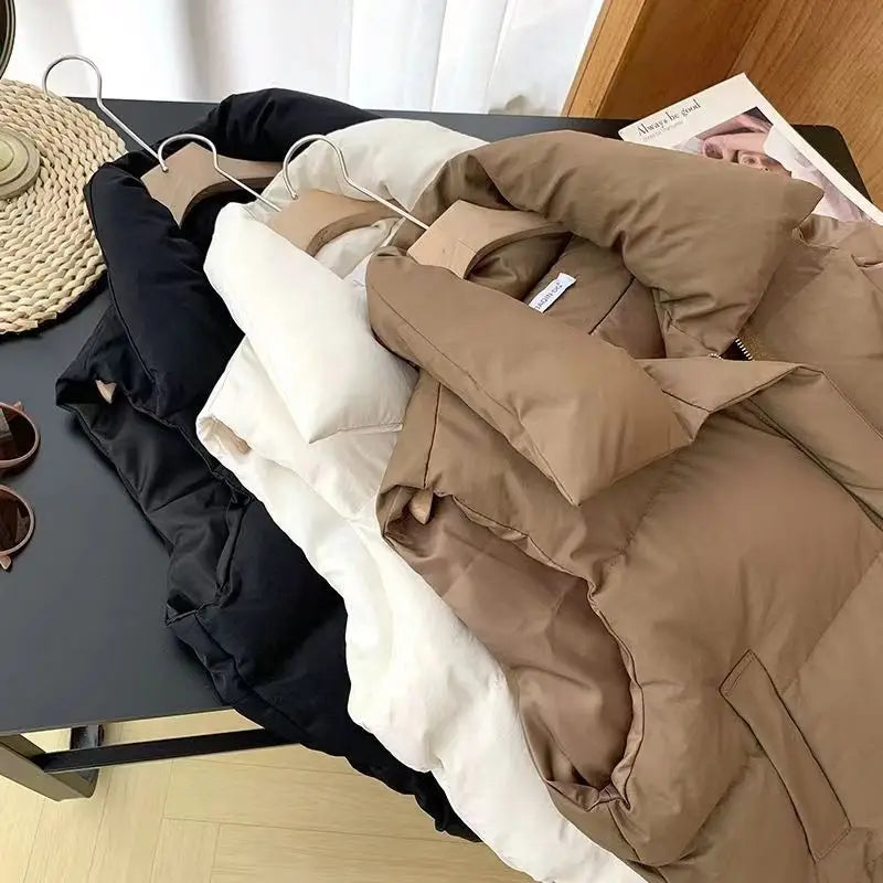 A cozy, warm beige women quilted puffer vest with a soft padded texture and subtle stitching details designed as loose sleeveless outerwear.
