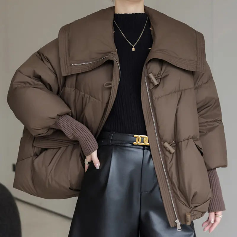 brown women short down puffer jacket featuring a wide fur collar and ribbed cuffs