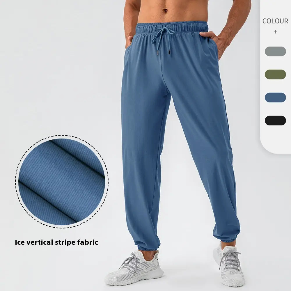 Men’s quick dry nylon loose fit athletic track pants in blue with ice vertical stripe fabric elastic waistband and drawstring.