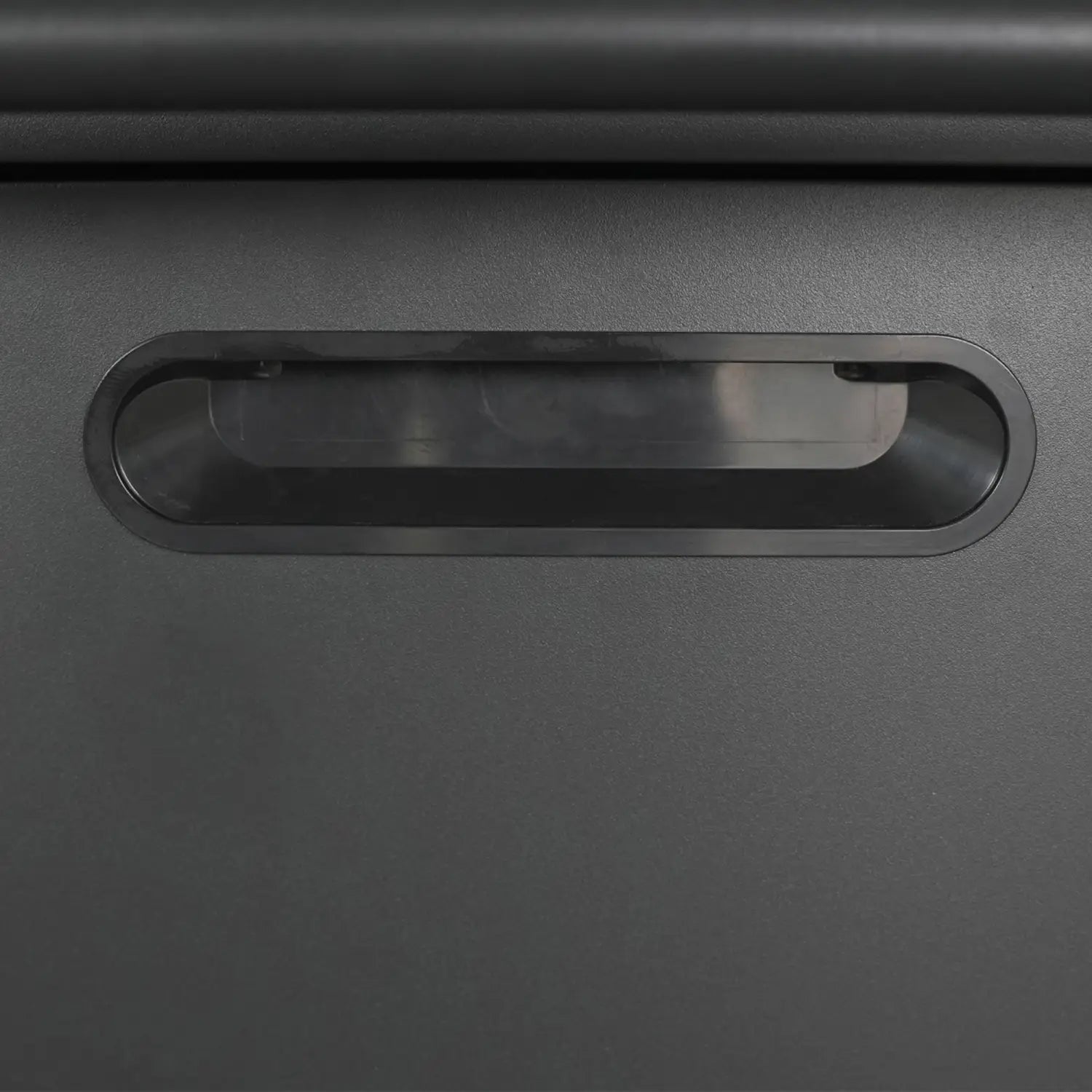 black plastic card slot with rounded edges and smooth matte finish on metal tool storage cabinet with four drawers and wheels