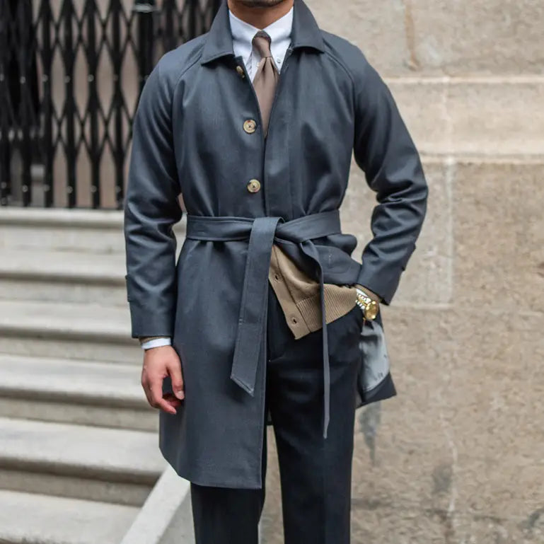 Dark gray wool winter trench coat with gold-toned buttons and a matching belt tied at the waist.