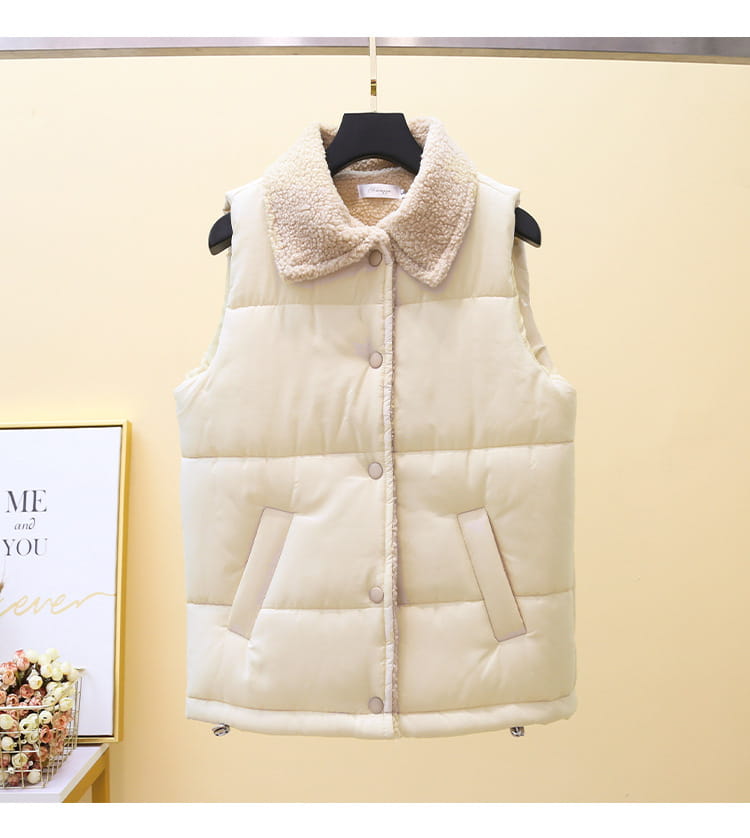Cream-colored quilted vest for women with plush fleece-lined collar and front pockets designed for warmth and comfort.