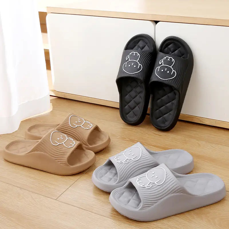 Black beige and gray rubber dog cartoon slide sandals feature non slip eva soles with white bear face designs on the footbed for house use.