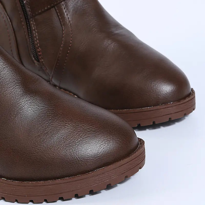 leather knee high knight boots in brown leather with a side zipper and textured rubber sole shown from the back