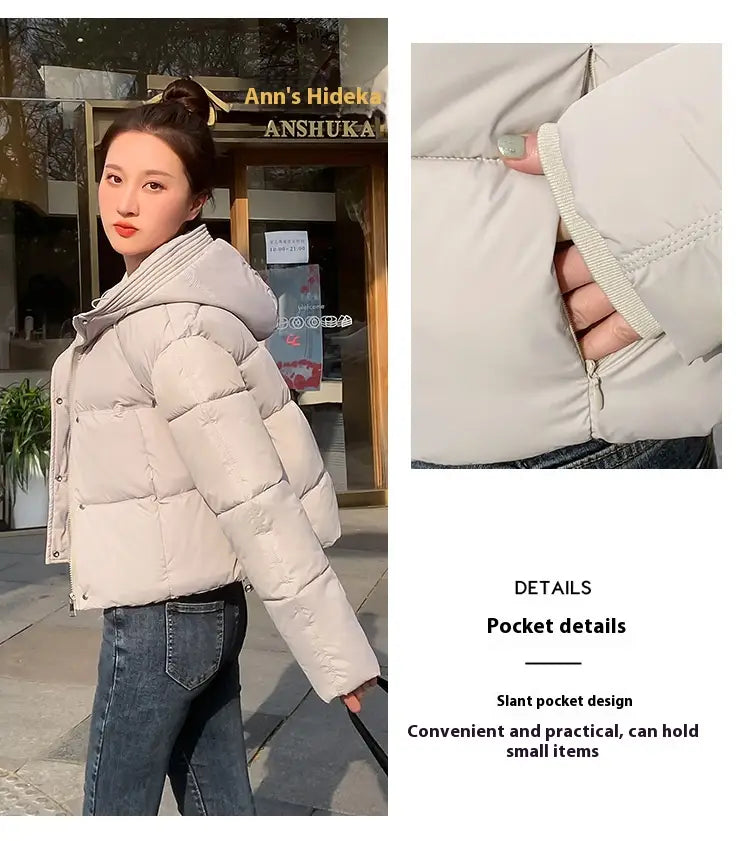 Women hooded short down jacket in off-white quilted puffer material with slanted pockets and ribbed cuffs.