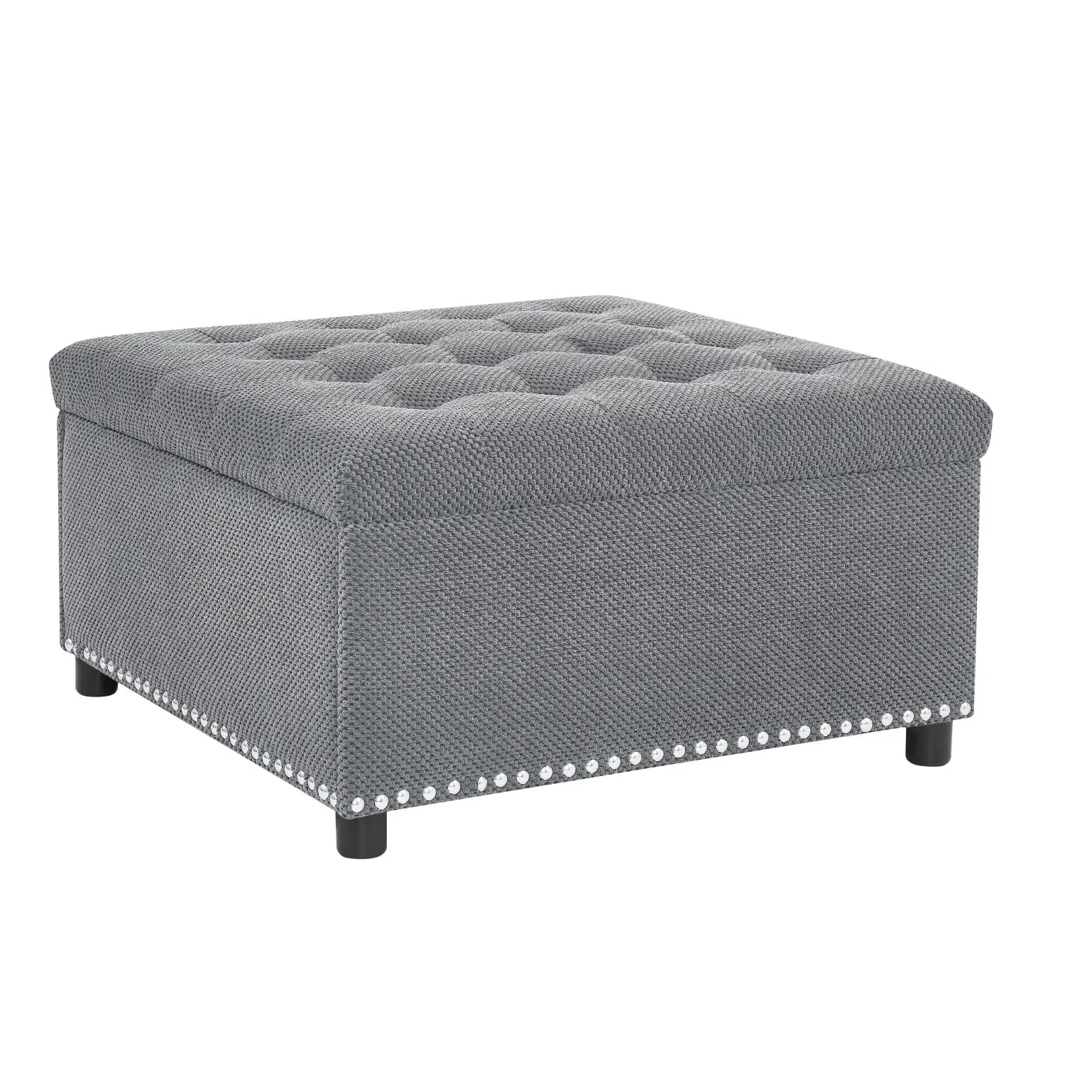 Gray tufted storage ottoman square with textured fabric finish and decorative nailhead trim along the base.