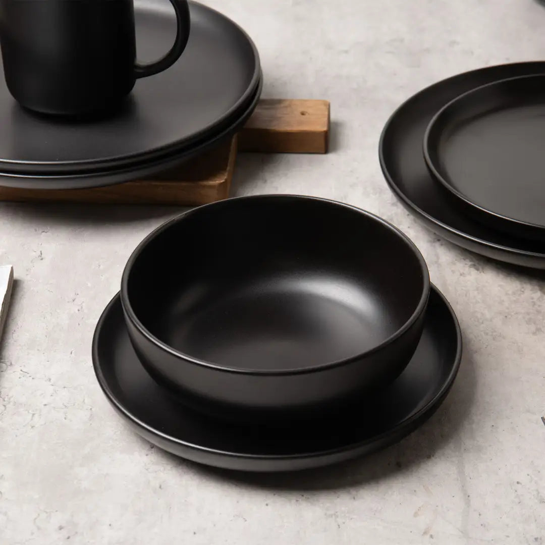 tazón de cerámica mate negro con platillo a juego, de un juego de vajilla de gres mate negro de 12 piezas para 3