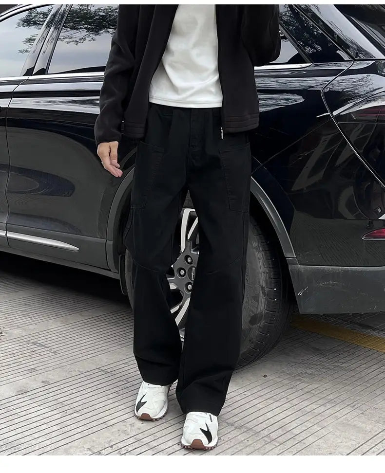 black wide-leg cotton cargo pants with multiple pockets and side seam zipper detail designed for mens workwear