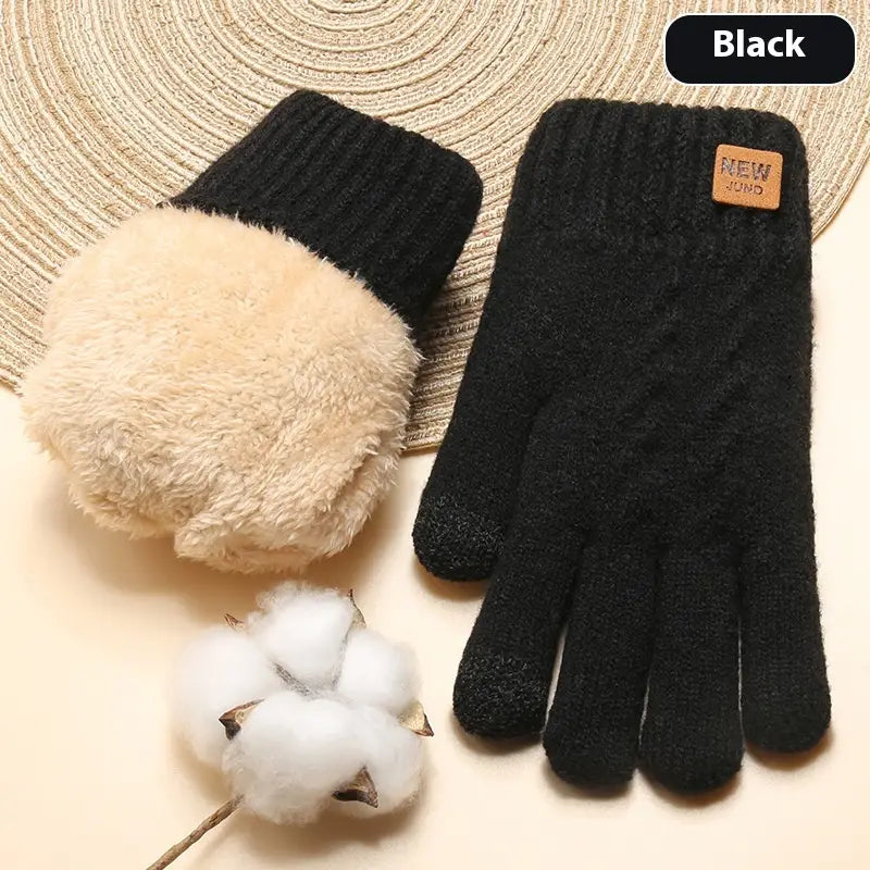 Black knitted thermal touchscreen winter gloves for women with fuzzy beige cuffs and a small brown leather patch shown from the back side.