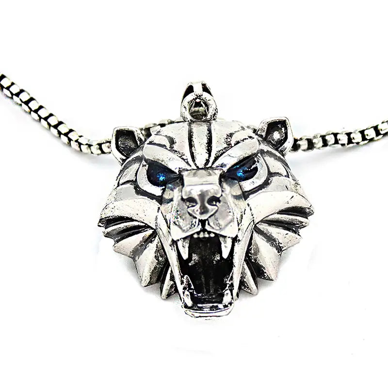 Silver tiger head pendant chain necklace featuring blue inlaid eyes and a textured fierce geometric wild game animal design.