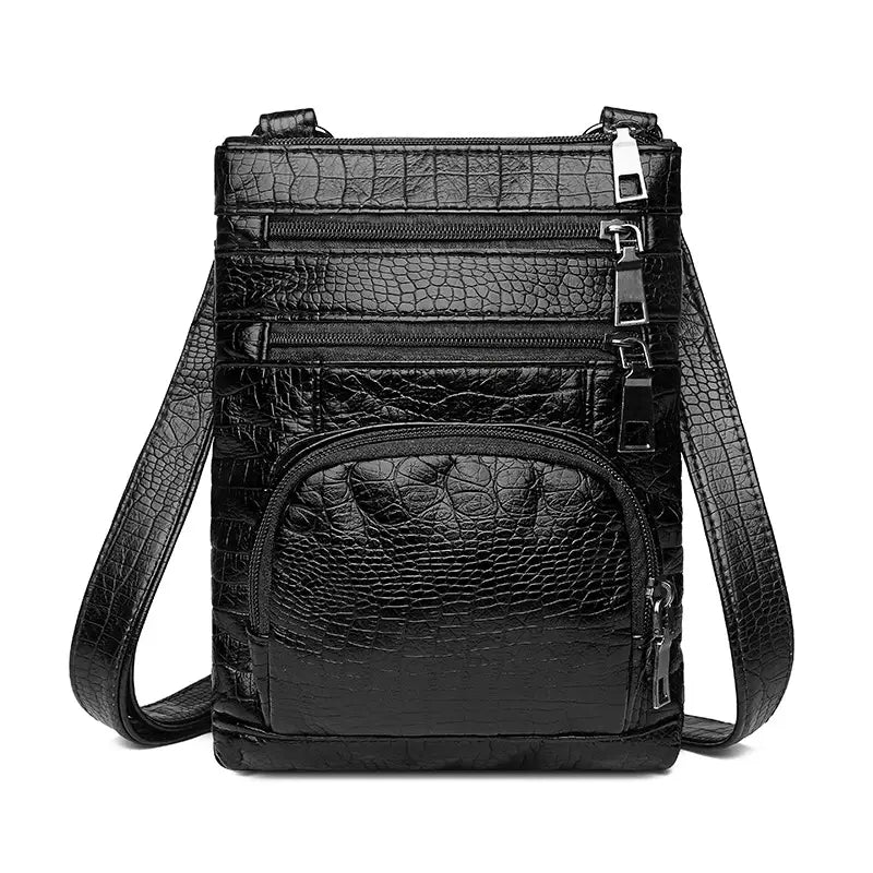 Black retro crocodile textured soft leather crossbody bag with multiple zippers and a detachable strap.