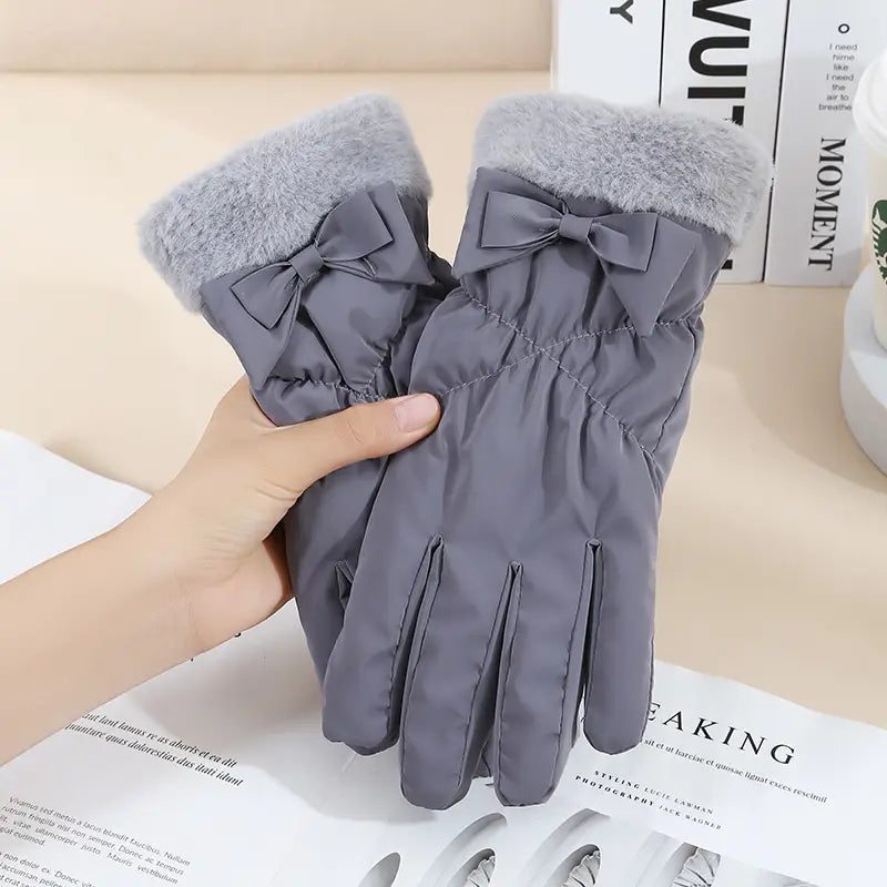 women touch screen winter fleece gloves in gray with fluffy cuffs and matching bow details shown from the back side
