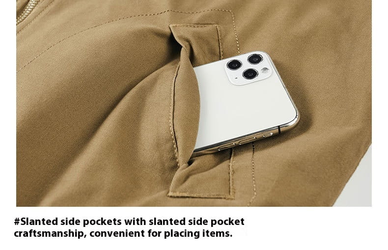 a white iphone with a triple-camera system nestled in the tan fabric pocket of a men cotton shearling bomber jacket