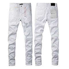 men’s distressed slim fit patchwork denim jeans in white denim with subtle fading and distressed detailing.
