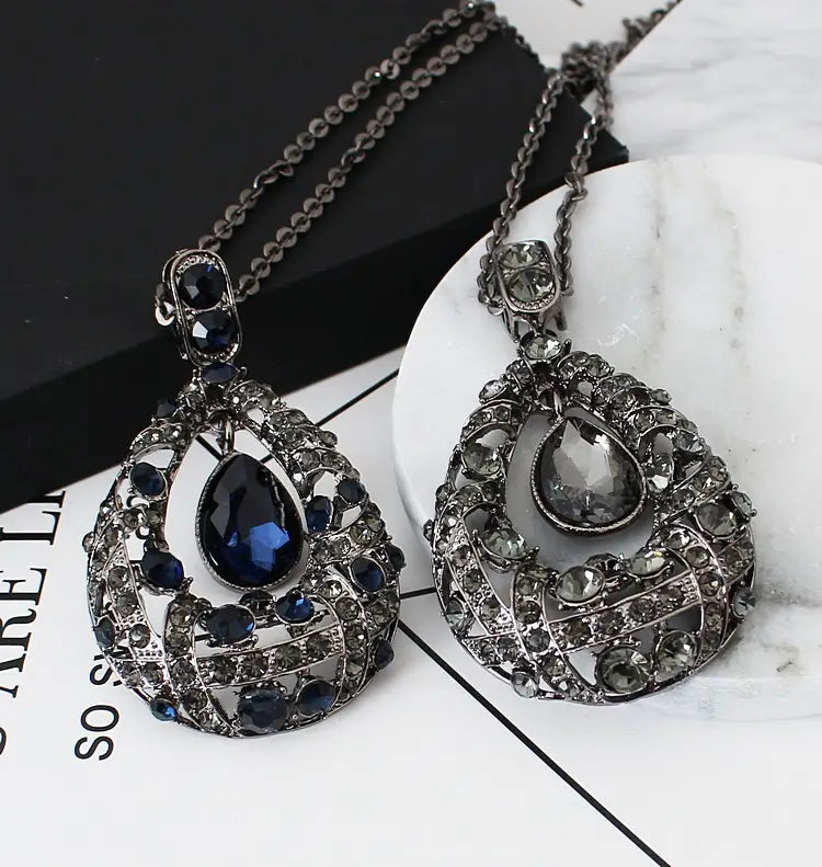 Elegant blue teardrop filigree pendant necklace in Korean style featuring intricate silver-toned metalwork with sparkling blue and clear crystals, designed as a sweater chain.