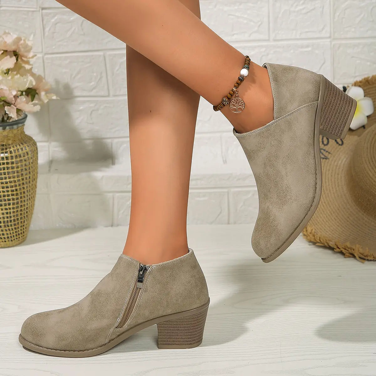 Beige suede ankle boot with chunky stacked heel and side zipper for easy wear.