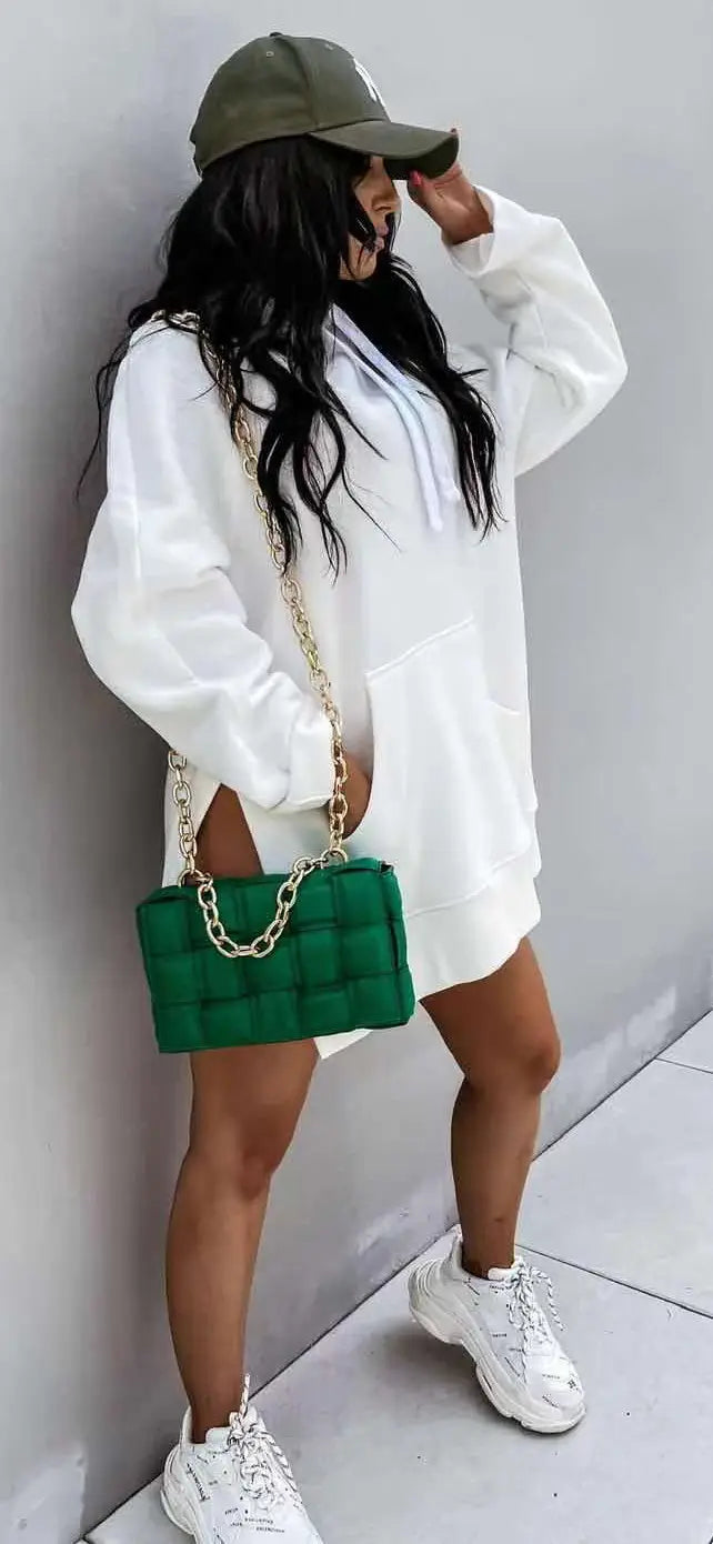 green quilted leather chain strap handbag paired with an oversized mid length hooded sweatshirt dress with pockets