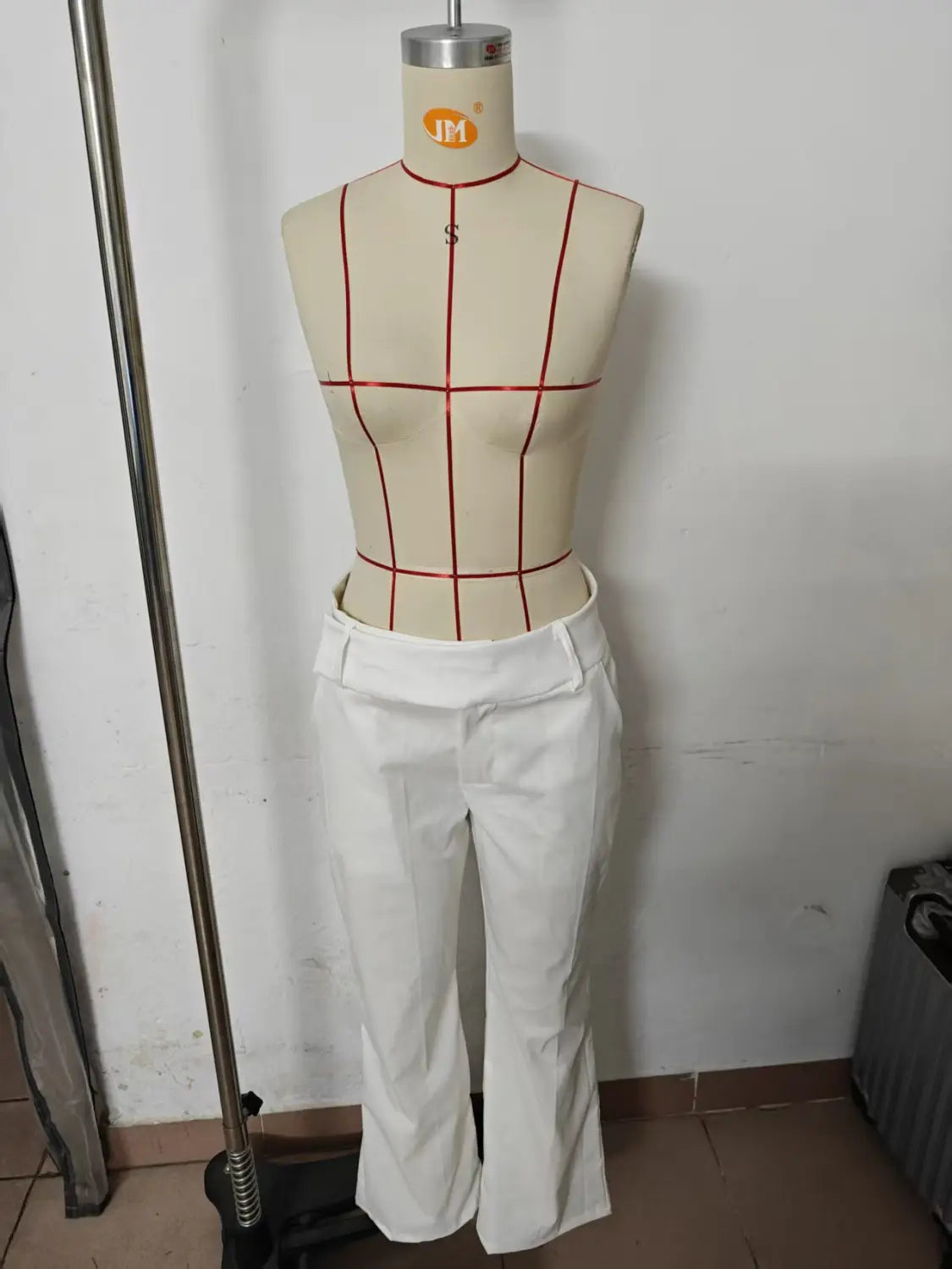 white tailored wide leg work pants with a high waist and flared legs displayed on a mannequin for casual wear