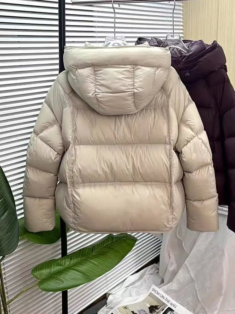 Beige puffer jacket loose hooded winter coat with quilted design and hood for cold weather.