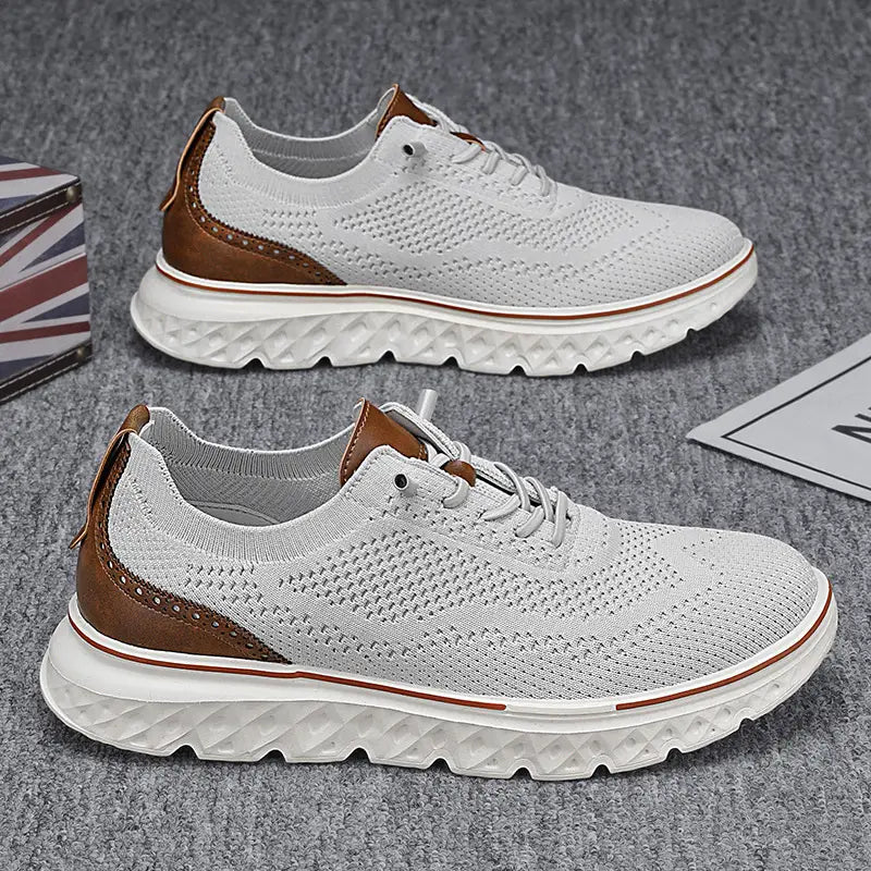 Men’s mesh knit casual lightweight sneakers in white knit with brown leather accents and a textured white rubber sole.