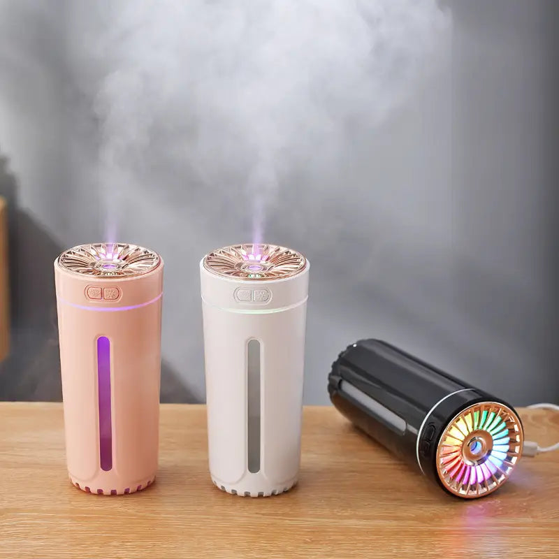 Three cylindrical usb-powered phantom cup humidifiers with silent operation in rose gold white and black finishes.
