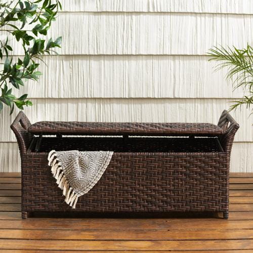 Brown woven wicker storage bench with a matching lid and decorative handles designed for outdoor seating.