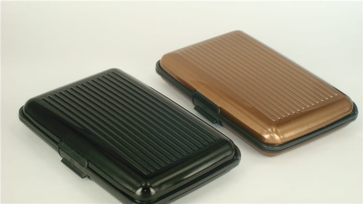 Black and bronze metallic rfid blocking aluminum alloy ribbed card holder cases with textured surfaces for secure card protection.
