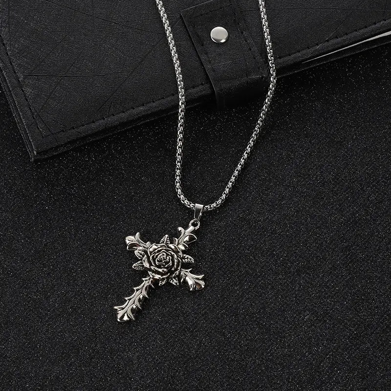 Detailed silver rose cross pendant necklace with an ornate chain and intricate floral design.