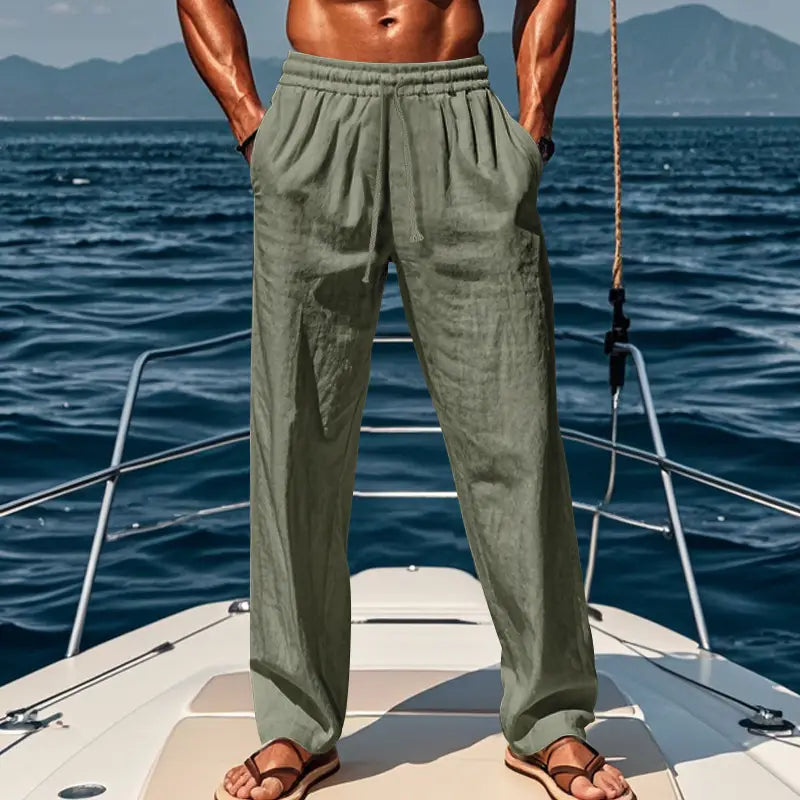 Men’s olive green linen joggers featuring an elastic waistband and side pockets designed for casual comfort.
