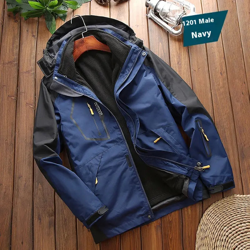 Men three-in-one waterproof winter sportswear jacket in navy blue and black with a fleece-lined hood, zippered pockets, and yellow zipper pulls.